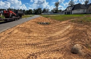After: reshaped and graded roadside ditch